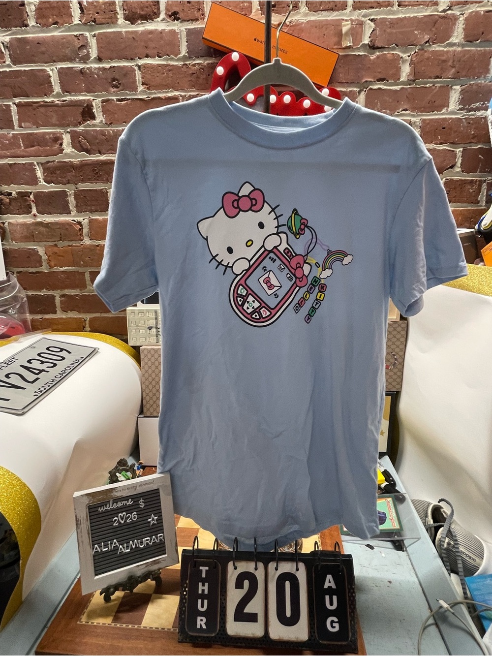 Hello Kitty Mobile Charm Graphic Tee features a Y2K-style